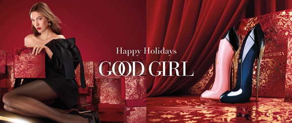 Parfém Carolina Herrera Good Girl ve tvaru lodiček na červeném svátečním pozadí s luxusními dárkovými krabicemi.
